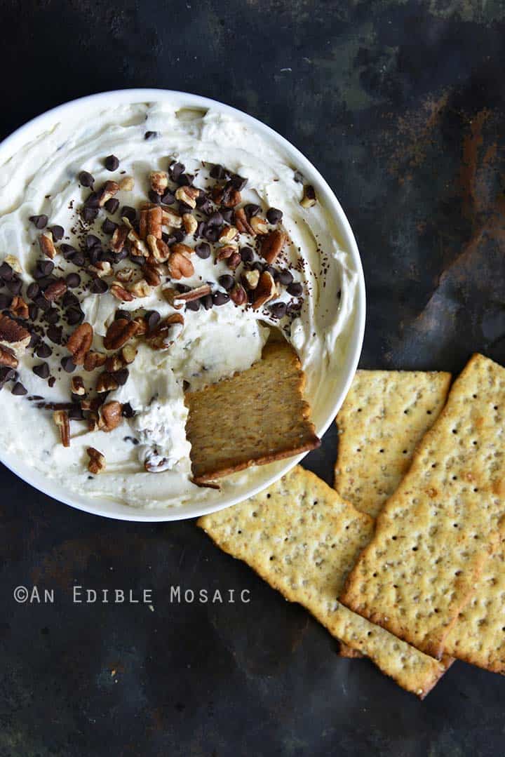 Easy Sugar-Free Turtle Cheesecake Dip with Crackers Being Dipped
