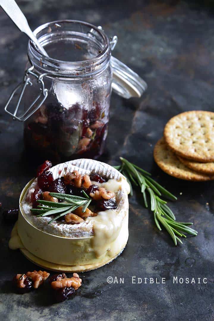 Gooey Baked Goat Brie with Spiced Rosemary-Scented Honey and Red Wine Cranberries Front View