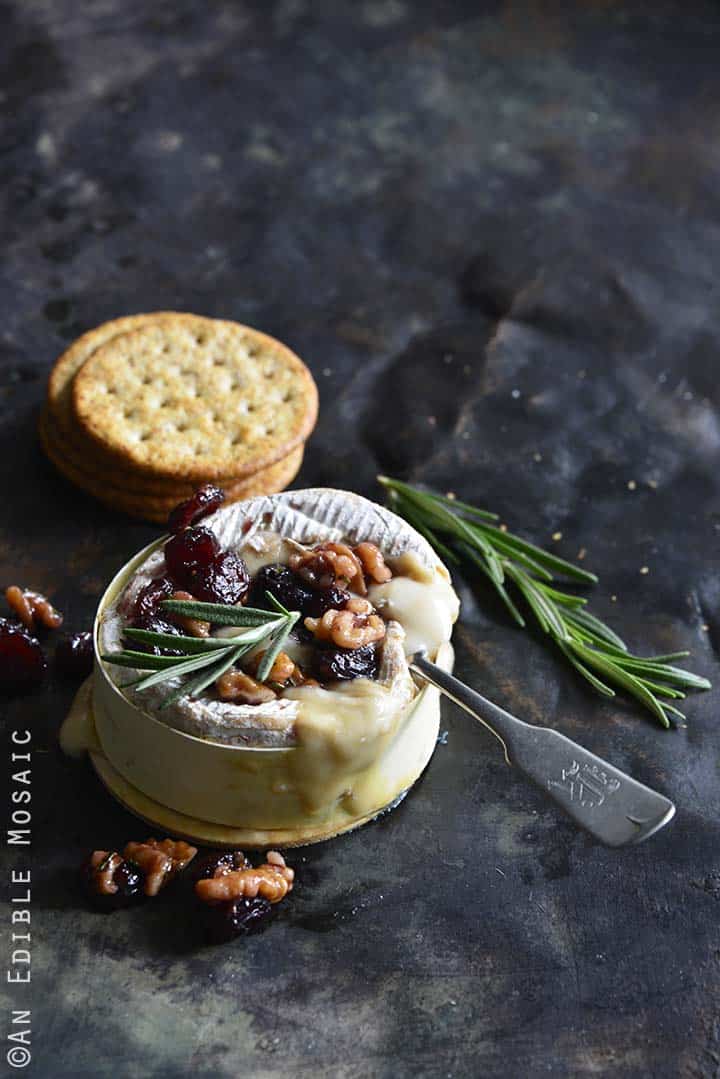 Gooey Baked Goat Brie with Spiced Rosemary-Scented Honey and Red Wine Cranberries Front View Vertical Orientation