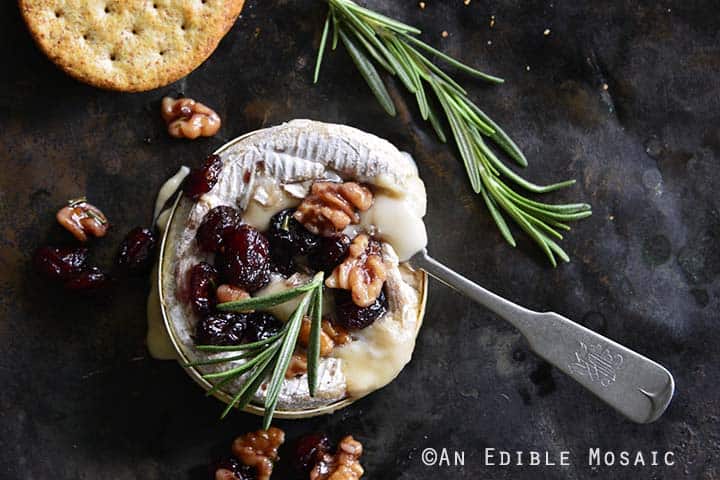 Gooey Baked Goat Brie with Spiced Rosemary-Scented Honey and Red Wine Cranberries Top View