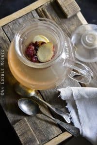 Pot of Honey-Apple Cranberry Ginger Tisane on Wooden Crate