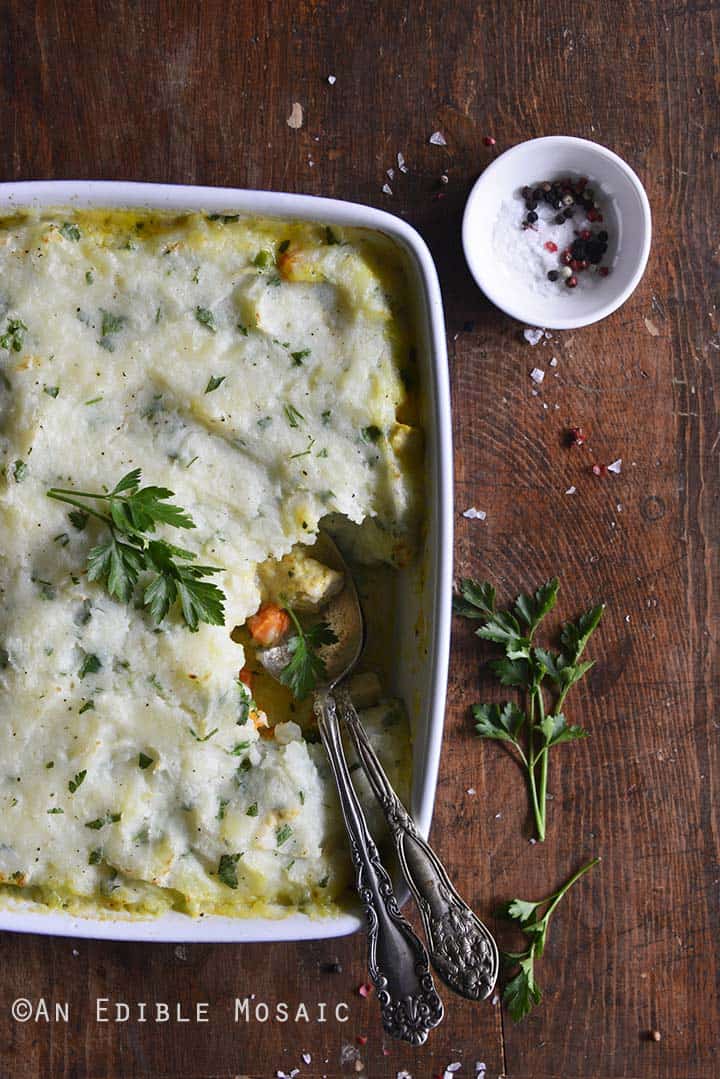 Chicken Pot Pie Topped with Garlic and Herb Potato Mash Overhead View on Wooden Table