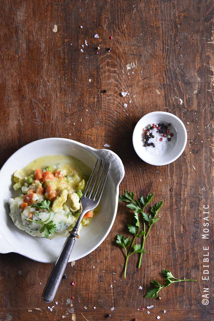 Dish of Chicken Pot Pie Topped with Garlic and Herb Potato Mash on Wooden Table