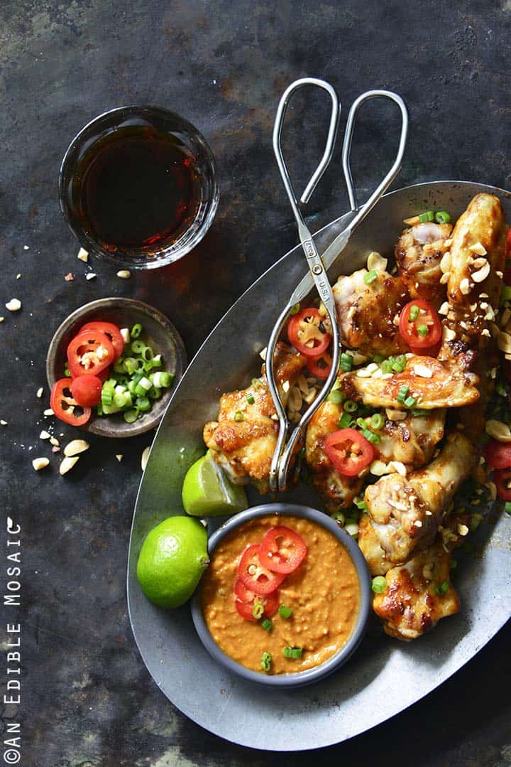 Chili-Garlic Glazed Wings with Peanutty Satay Dipping Sauce on Tray with Drink