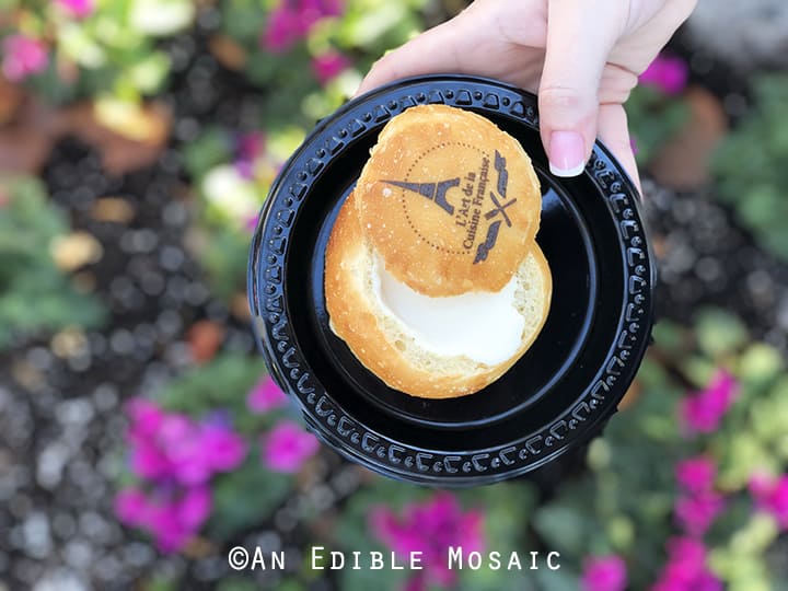 Warm Creamy Brie in a Housemade Bread Bowl with Flowers in Background at Epcot