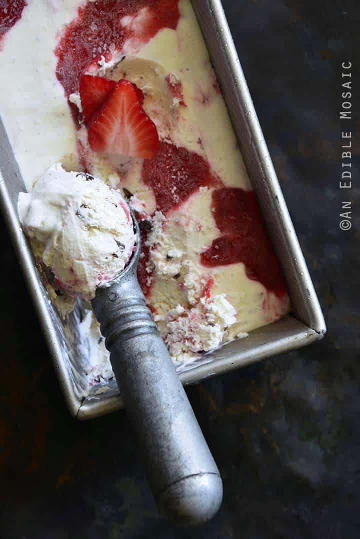 Scooping Low-Carb Keto No-Churn Vanilla Cheesecake Ice Cream with Strawberry Swirl and Chocolate Chunks
