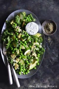 Kale, Roasted Zucchini, and Green Pea Salad with Creamy Za’atar Dressing on Vintage Metal Tray