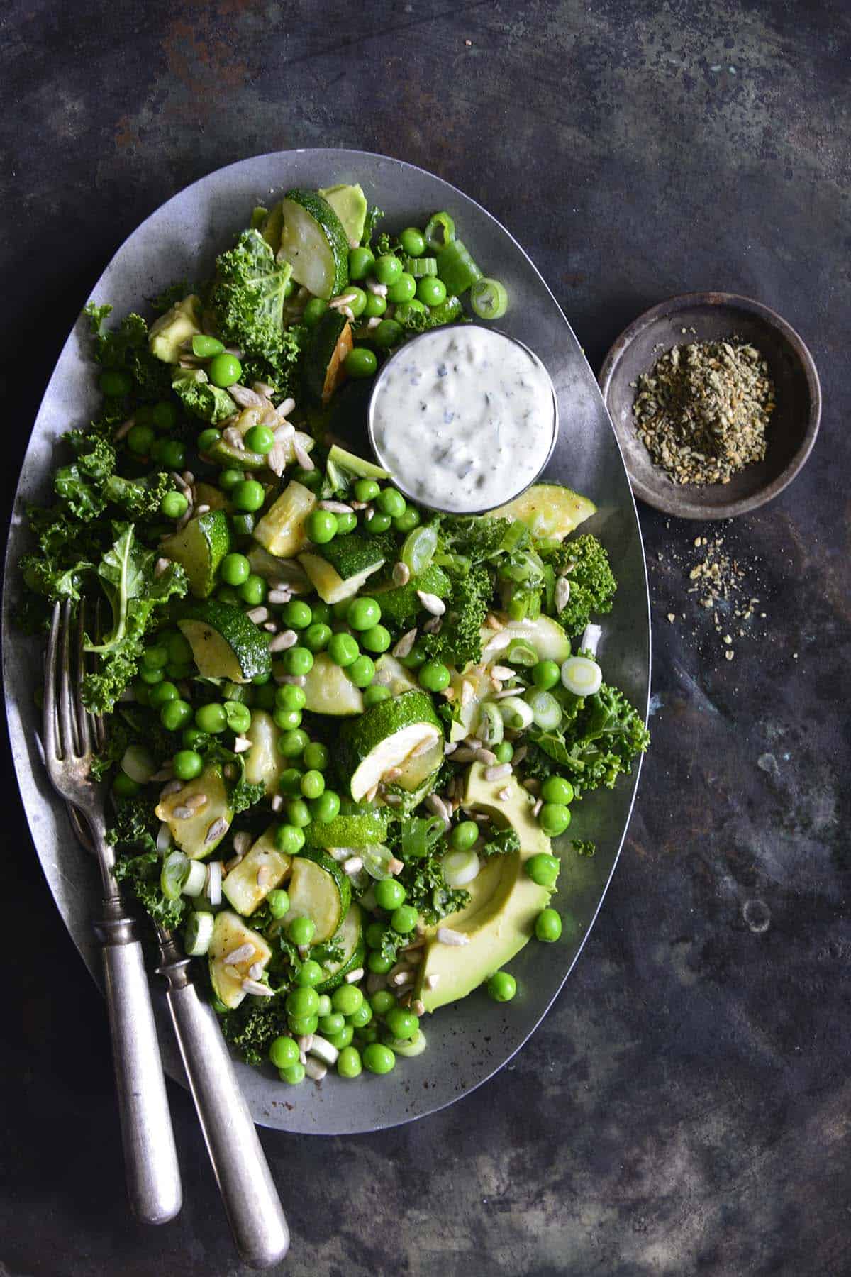 overhead view of roasted vegetable salad with creamy zaatar dressing