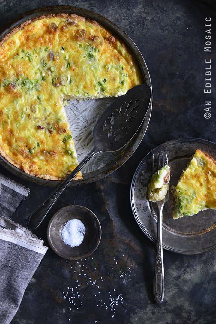 Low-Carb Keto Quiche Lorraine in Tart Dish with a Single Serving on a Plate on the Side