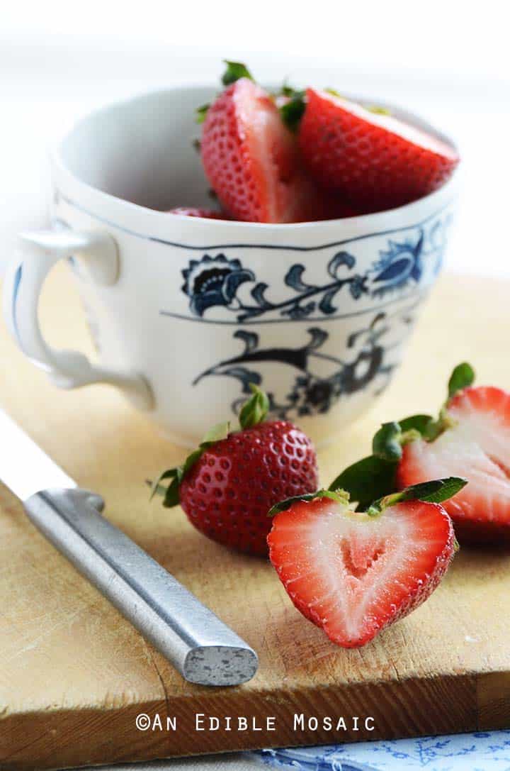 Fresh Strawberries in Blue and White Tea Cup on Cutting Board