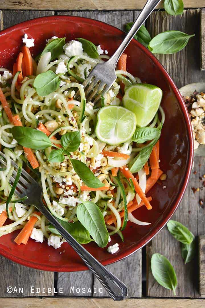 Low Carb Spiralized Cucumber Salad with Peanuts, Basil, and Ginger Miso Dressing on Wooden Table