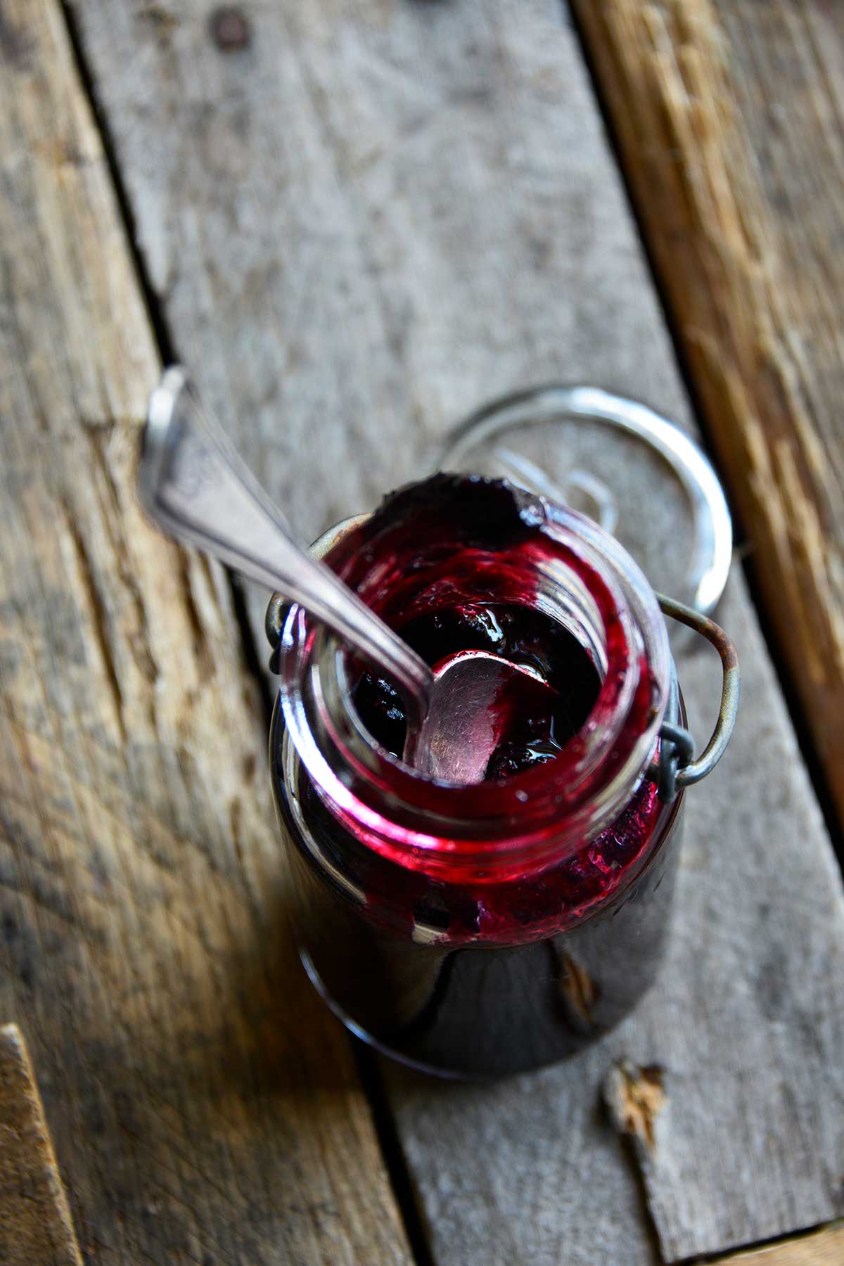 vintage glass jar of sugar free blueberry jam on wooden crate