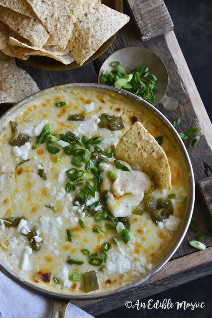 Pan of Easy Low Carb Chile Relleno Dip (15 Minute Dip Recipe) with Scallions on Wooden Table