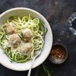 Bowl of Low Carb Cheesy Turkey Meatballs with Rosemary Cream Sauce on Metal Tray