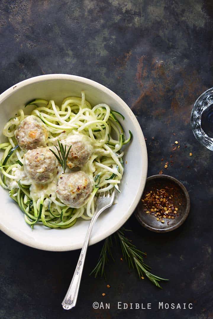 Bowl of Low Carb Cheesy Turkey Meatballs with Rosemary Cream Sauce on Metal Tray