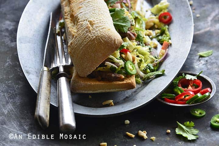 Front View of Banh Mi Sandwich with Instant Pot Short Ribs and Quick Pickled Slaw on Serving Platting with Antique Silverware