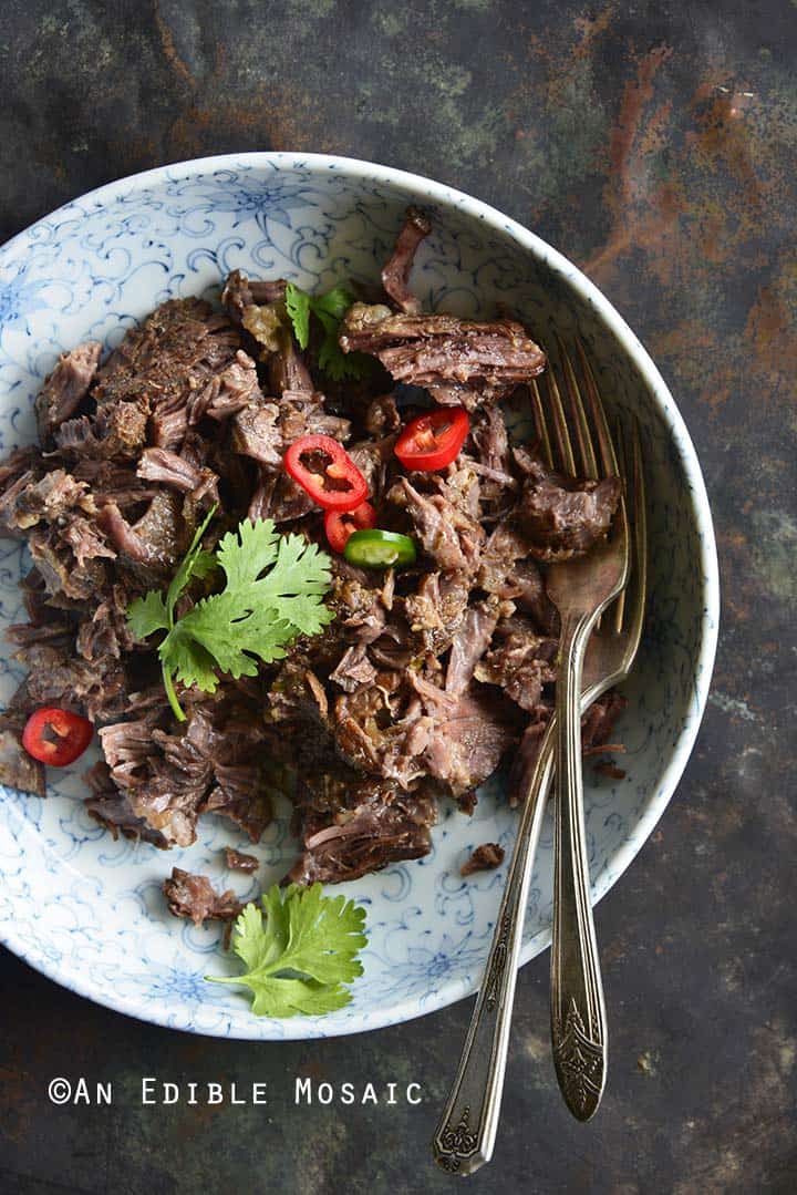 Cooked Short Ribs in Blue and White Bowl on Dark Tray