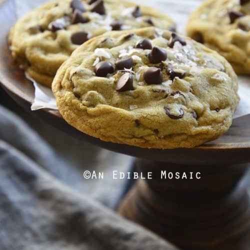 Small Batch Bakery Style Chocolate Chip Cookies on Wooden Pastry Stand with Dark Linen