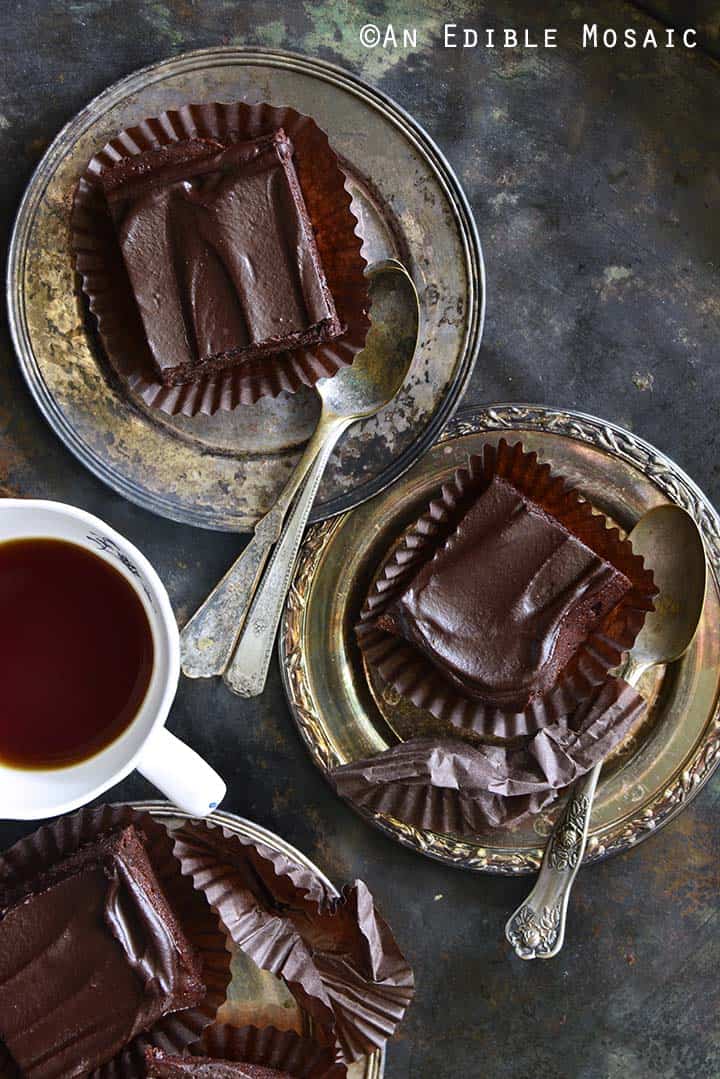 Slices of Fudgy Guinness Brownies with Dark Chocolate Ganache Recipe on Silver Trays with Vintage Spoons