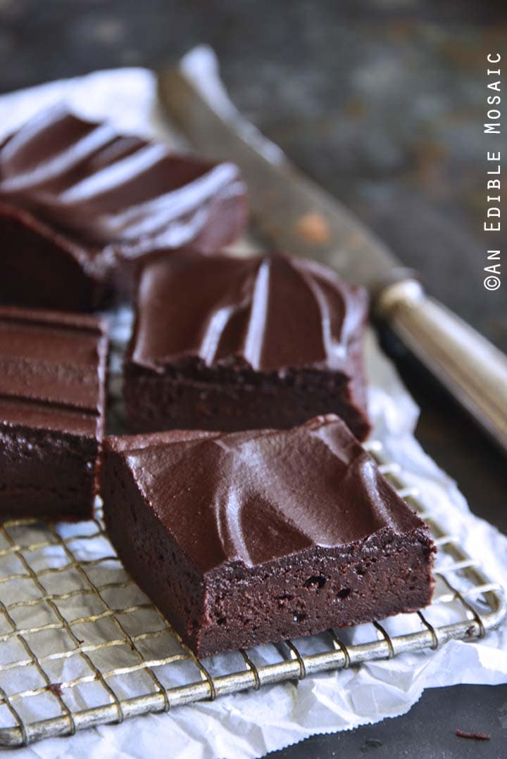 Fudgy Guinness Brownies with Dark Chocolate Ganache Cooling on Wire Rack on Parchment Paper