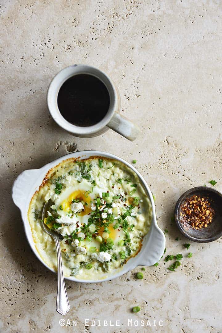 Herbed Eggs Baked in Cream with Feta and Coffee on Creamy Marble Background