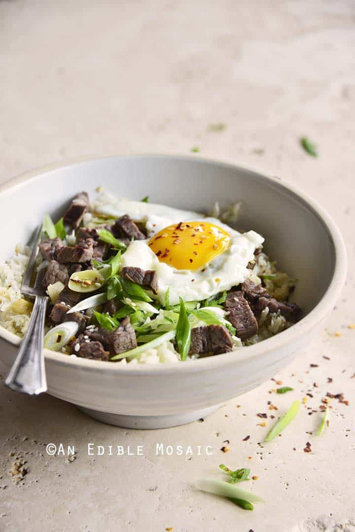 Front View of Low Carb Chili Garlic Steak Rice Bowl with Fried Egg