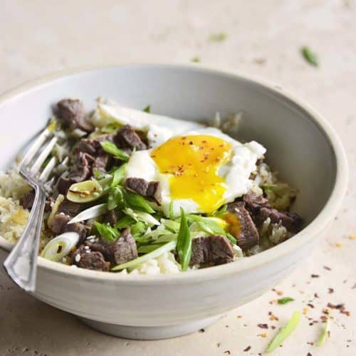 Bowl of Low Carb Chili Garlic Steak Rice with Runny Yolk