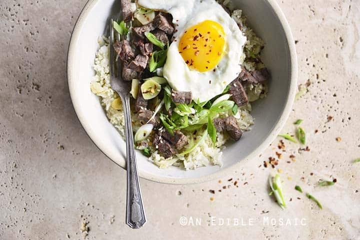 Close Up of Low Carb Chili Garlic Steak Rice Bowl with Fried Egg on Top