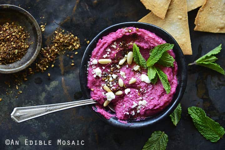 Pickled Beet Hummus on Dark Metal Tray with Tortilla Chips