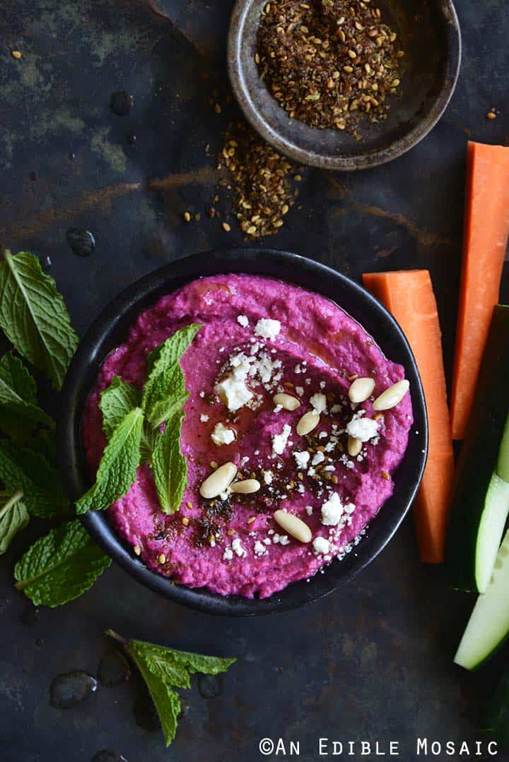 Pickled Beet Hummus with Za'atar and Vegetable Sticks on Dark Background