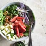 Overhead View of Spinach Strawberry Salad on Creamy Marble Background