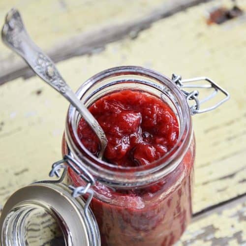 Jar of Sugar Free Strawberry Jam on Rustic Yellow Wooden Table