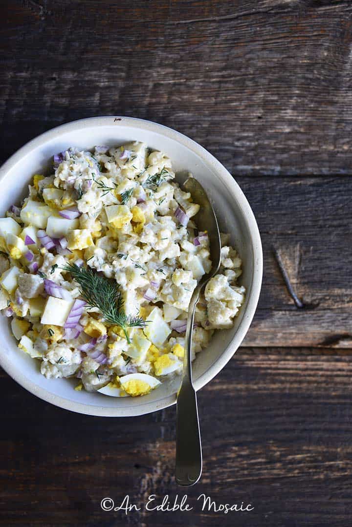 Cauliflower Potato Salad on Dark Wooden Board Overhead View