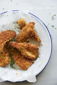 Coconut Chicken Tenders on White Plate with Blue Rim