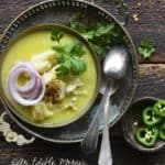 Overhead View of Coconut Fish Curry on Vintage Metal Tray on Dark Wooden Table
