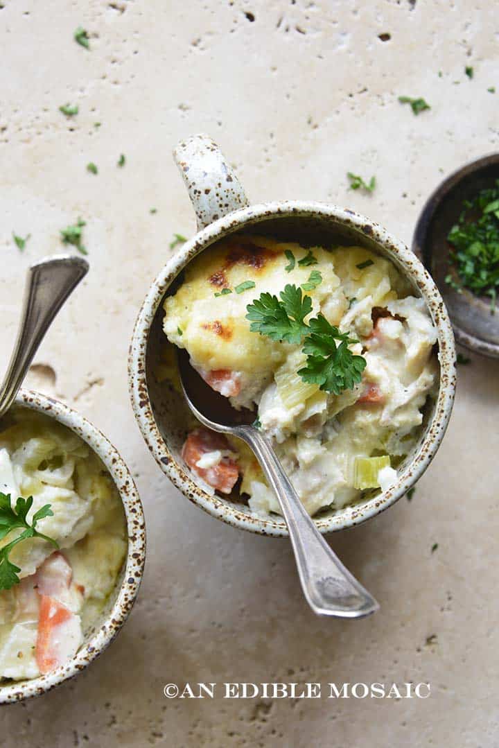 Creamy Chicken Casserole with Cheesy Cauliflower Mash in Ceramic Mugs on Creamy Background