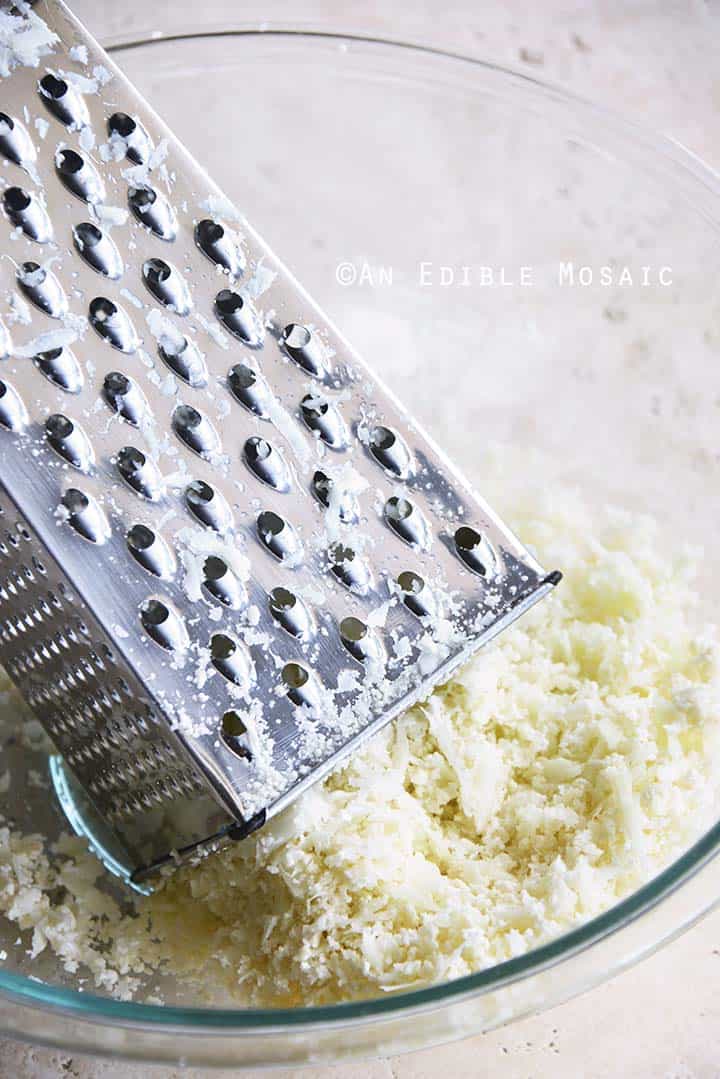 Grating Raw Cauliflower on Box Grater