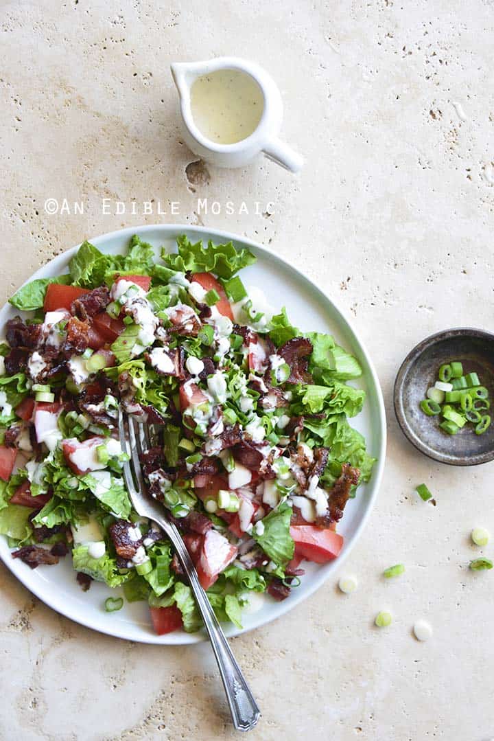 BLT Salad on White Plate with Side of Dressing and Dish of Sliced Scallions