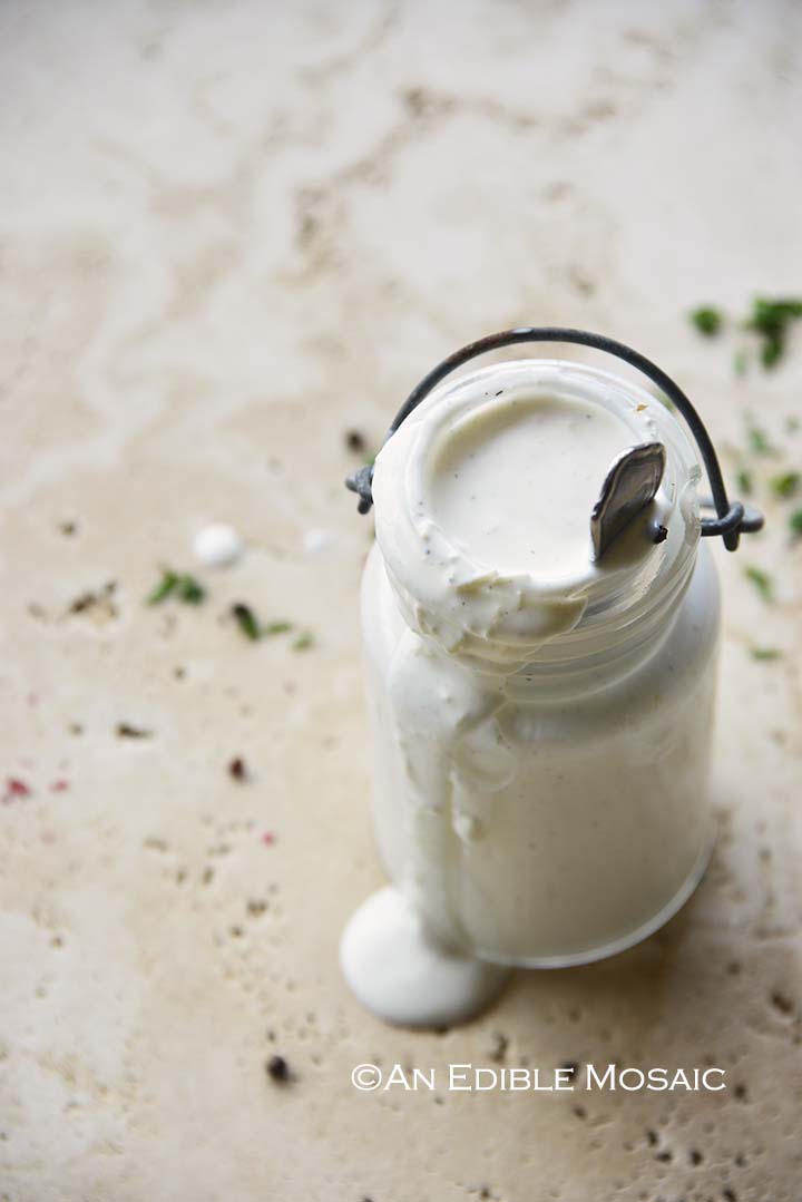 Parmesan Peppercorn Dressing with Dressing Dripping Off Jar