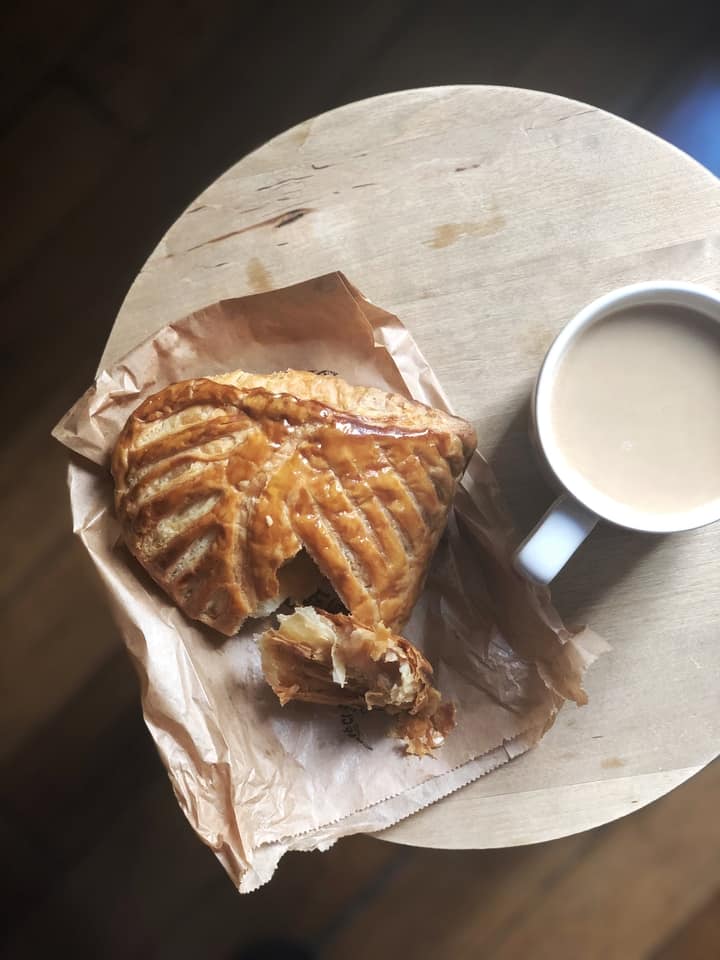 Chaussons aux Pommes with Cream Coffee on Wooden Table