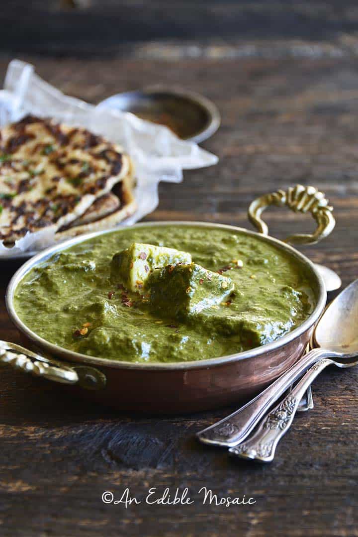 Palak Paneer Recipe (Indian Spinach Curry with Paneer Cheese) Close Up Front View on Wooden Table