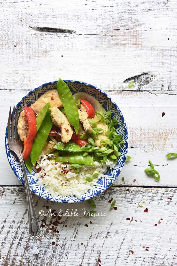 Overhead View of Healthy Sweet and Sour Chicken Stir Fry Recipe in Blue and White Bowl on White Table