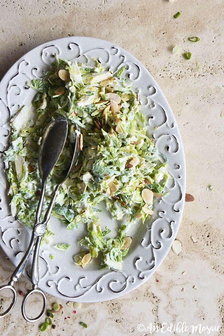 Overhead View of Creamy Brussels Sprouts Salad on Serving Platter on Creamy Marble Table