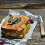 Grilled Cheese Thanksgiving Leftovers Sandwich on White Parchment Paper with Paring Knife