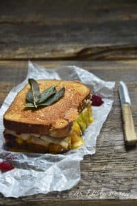 Grilled Cheese Thanksgiving Leftovers Sandwich on White Parchment Paper with Paring Knife