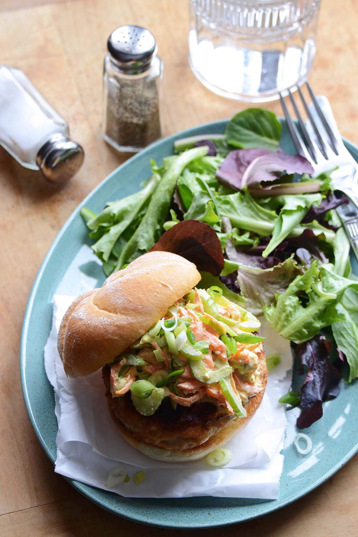 easy buffalo chicken burger with blue cheese coleslaw on top