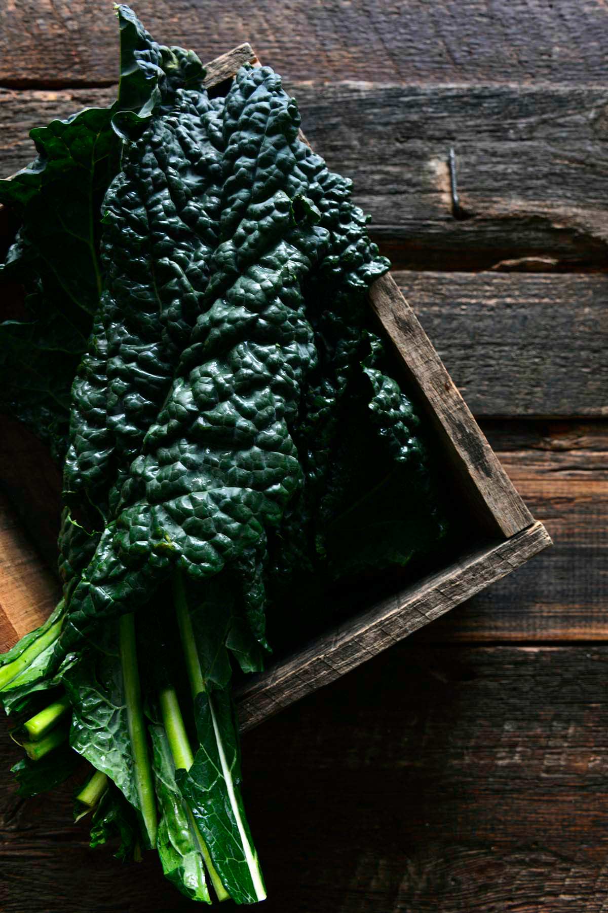 fresh dinosaur kale in wooden crate