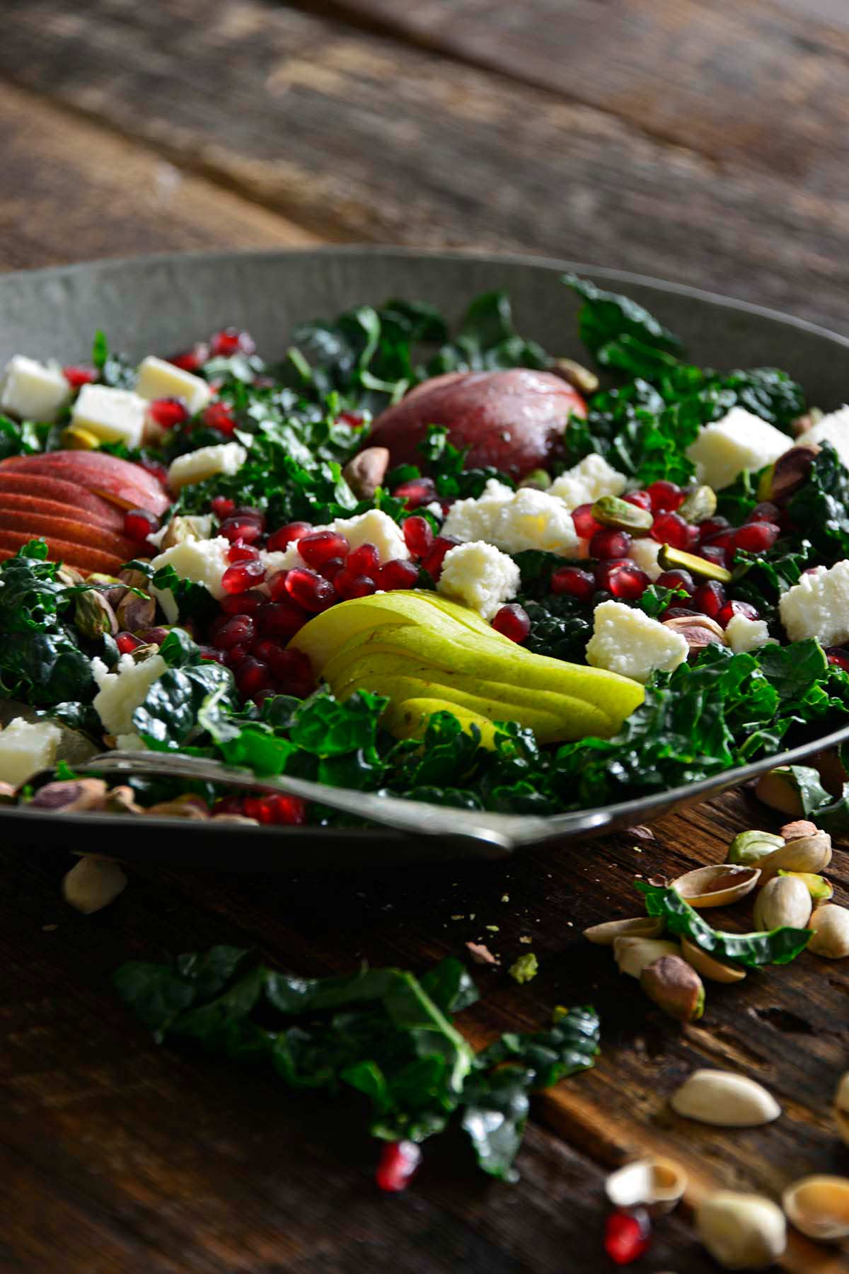 front view of winter salad with pears pistachios and pomegranate
