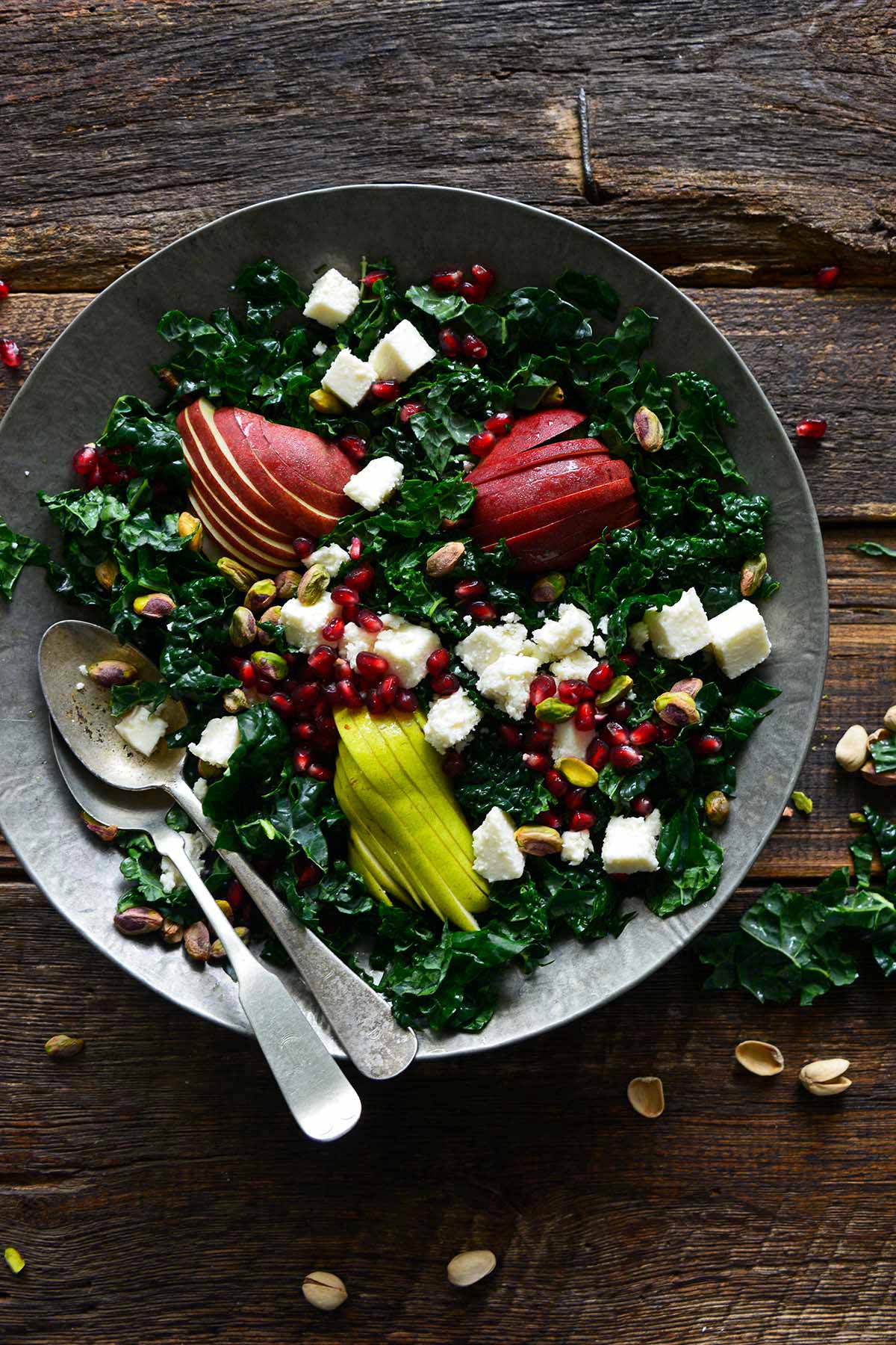 leafy green salad with pistachios white cheese and pomegranate arils