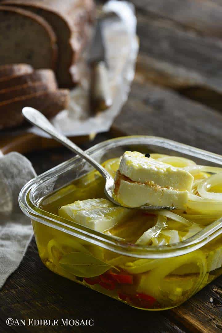 Close Up of Czech Pickled Cheese in Glass Dish with Brown Bread in Backgroud